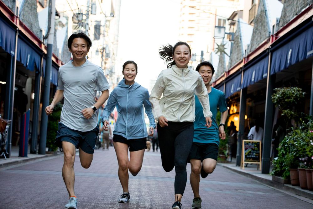 A group of people running on a street