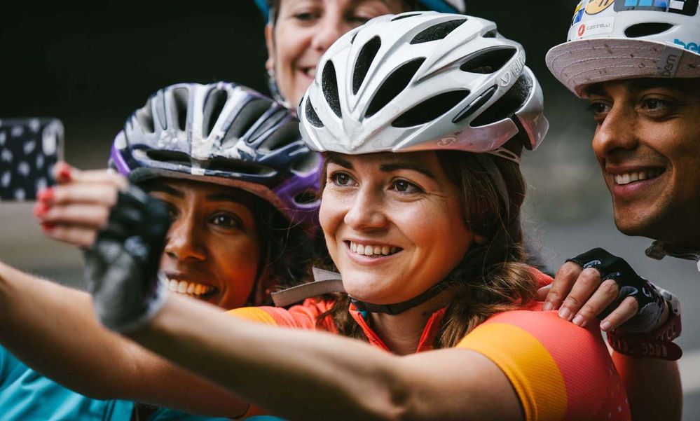 Image of a group of cyclists taking a photo of themselves.