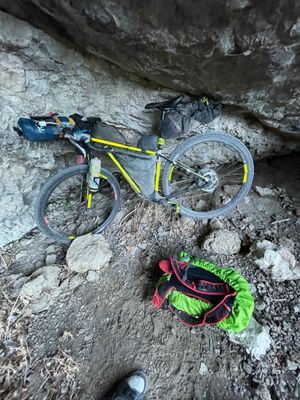 My bike inside the cave, i.e., a deep recession in the cliff wall.