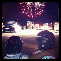 My kids watching the pacecar zoom by with the fireworks in the Friday night Blue Dome stage of the 2012 Tulsa Tough weekend. The fireworks didn't start until a few laps to go. It was surreal.